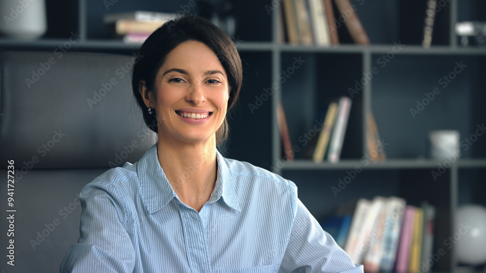 Businesswoman smiling while sitting in office Businesswoman smiling while sitting in office