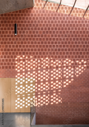 Modern auditorium interior with perforated brick wall design