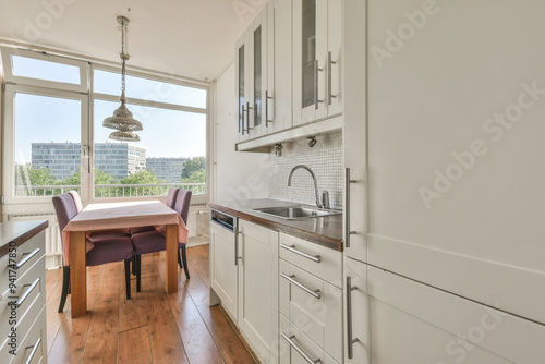 Modern kitchen interior with dining area and city view
