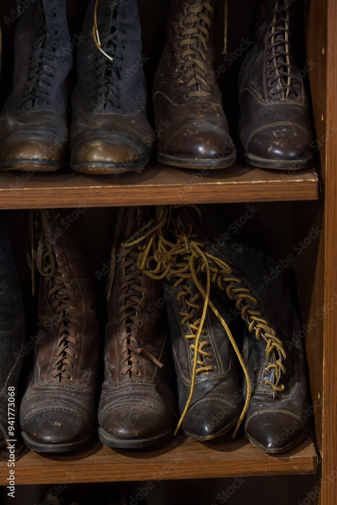 Old fashioned shoes and boots on shelves Old fashioned shoes and boots on shelves