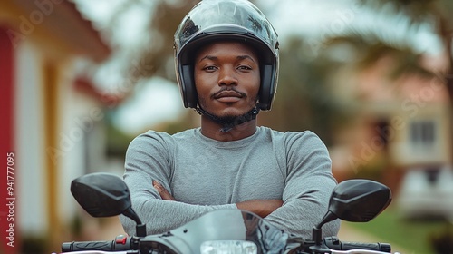 Man on motorbike wearing helmet and plain gray long-sleeved t-shirt. Motorcycle courier, delivery