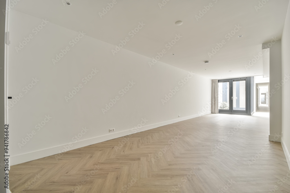 Spacious empty room with herringbone parquet flooring Spacious empty room with herringbone parquet flooring