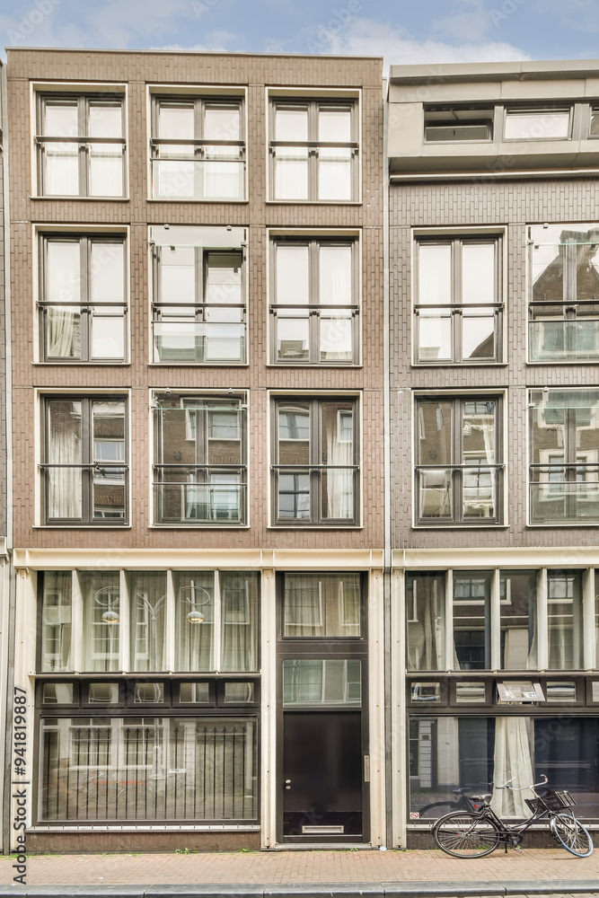 Modern urban brownstone building with bicycle Modern urban brownstone building with bicycle
