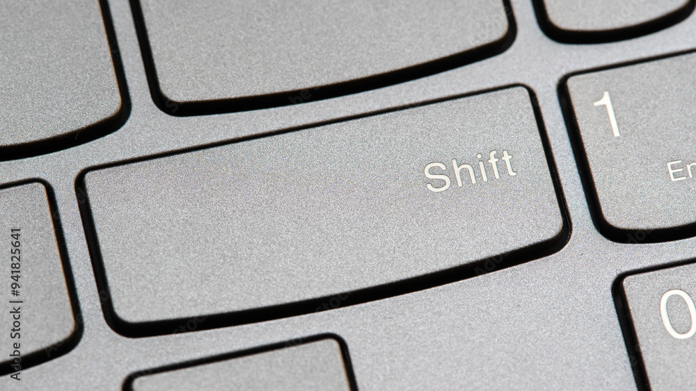 Man Pressing The Shift Key On A Modern Laptop Computer Keyboard Closeup man-pressing-the-shift-key-on-a-modern-laptop-computer-keyboard-closeup