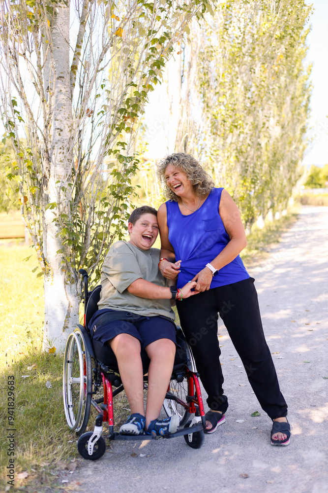Smiling boy with cerebral palsy enjoying time with his mother outdoors Smiling boy with cerebral palsy enjoying time with his mother outdoors