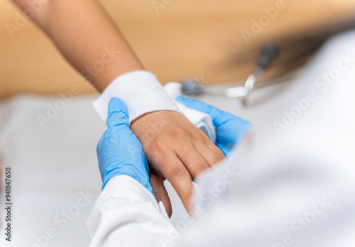 A doctor cures a patient with a bandage on his hand