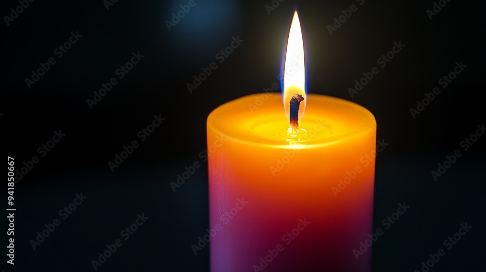 A vibrant orange candle burns softly, casting a warm glow in a dark setting, creating an inviting and serene atmosphere. A vibrant orange candle burns softly, casting a warm glow in a dark setting, creating an inviting and serene atmosphere.