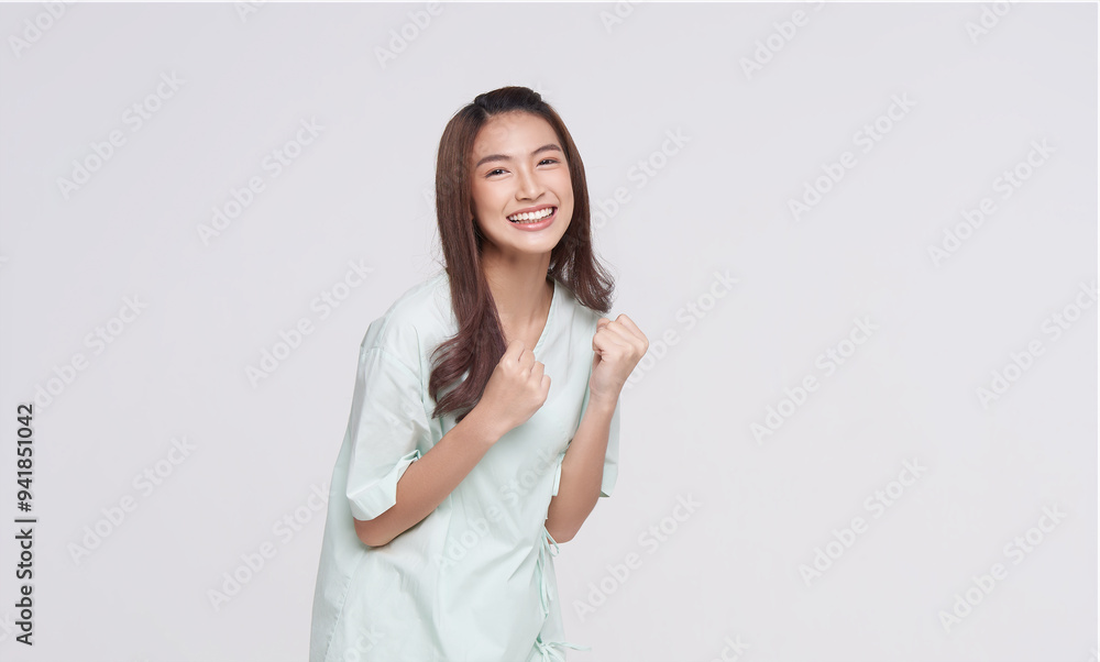 Happy asian woman patient raise fist gesture fight disease isolated on white studio background. life insurance and coverage concept. Happy asian woman patient raise fist gesture fight disease isolated on white studio background. life insurance and coverage concept.