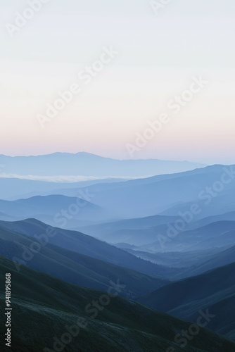 Morning mist envelops the rolling hills at dawn in tranquil mountains