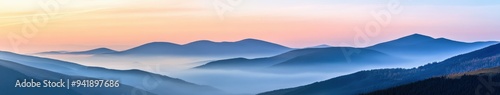 Misty morning view of rolling hills at sunrise over the landscape