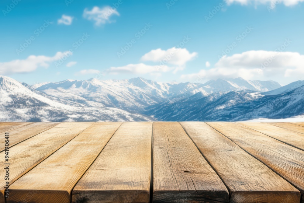 A scenic view of snow-covered mountains under a clear blue sky, with a warm wooden table in the foreground. A scenic view of snow-covered mountains under a clear blue sky, with a warm wooden table in the foreground.