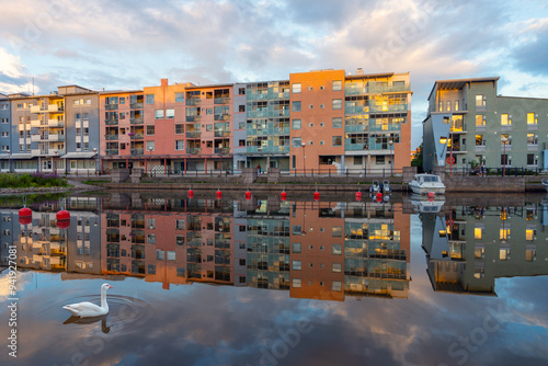 View looking across Pikku Huopalahti in Helsinki, Finland, showing modern apartment buildings with their reflections on the water photo