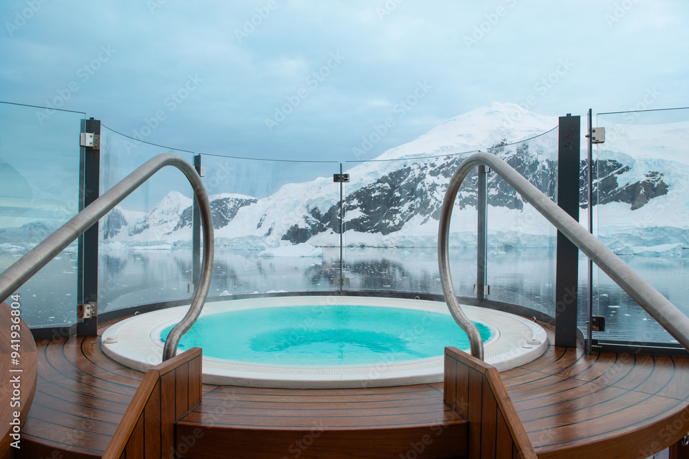 Outdoor hot tub against snow mountain landscape in Antarctica.