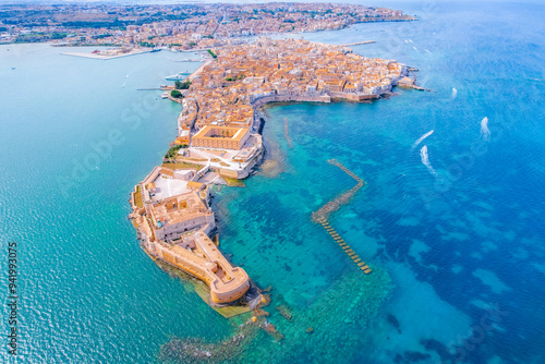 Aerial of Ortigia island, old town with turquoise sea of Syracuse. Small island on Sicily, Italy. photo