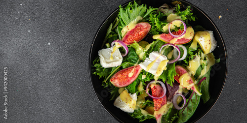 salad fig fresh green lettuce, figs, soft cheese meal food snack on the table copy space food background rustic top view vegetarian vegan food