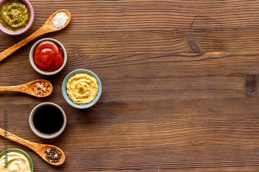 Set of sauces in bowls with spices in spoons and ingredients, top view Set of sauces in bowls with spices in spoons and ingredients, top view