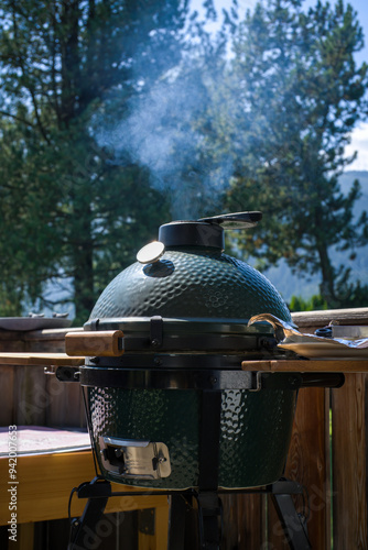 grilling at a sunny summer day on the terrace in the garden