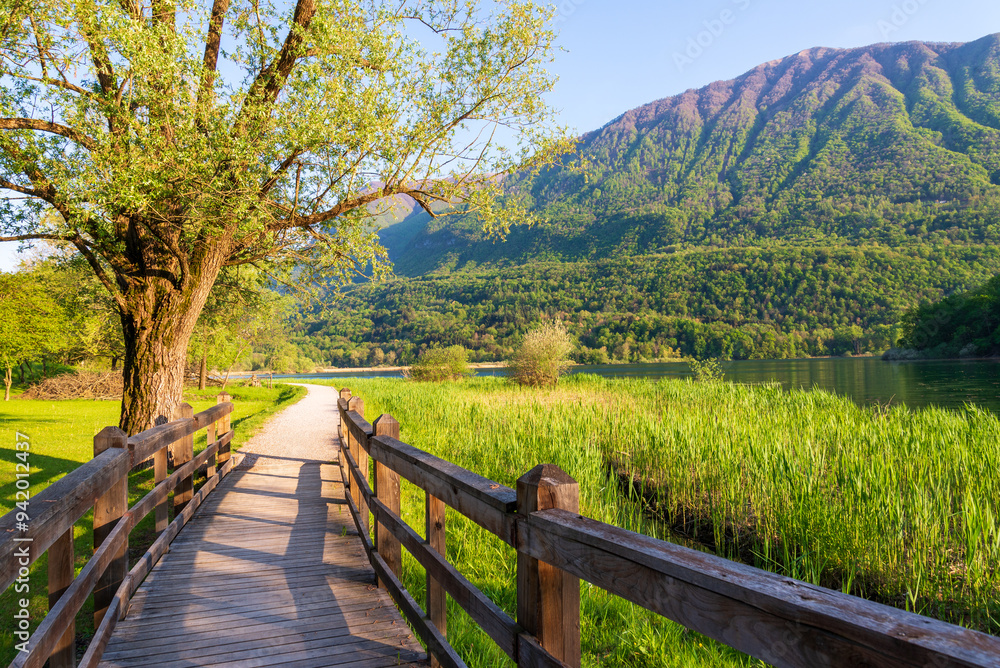 Carlazzo, Italy: paths along the shores of Lago Piano. Small nature reserve located in Val Menaggio. It has an area of 0.72 km2 and a maximum depth of 13 meters and it is located near Porlezza town Carlazzo, Italy: paths along the shores of Lago Piano. Small nature reserve located in Val Menaggio. It has an area of 0.72 km2 and a maximum depth of 13 meters and it is located near Porlezza town