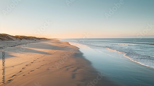 Serene Morning on Saint-Jean-de-Monts Beach in France, with the Sun Rising Over the Horizon and Casting a Soft Light on the Calm Sea