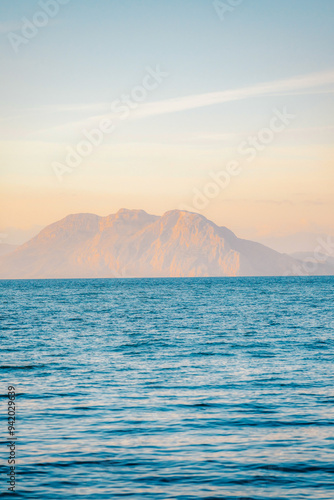 Sunset from the coast with a view of the The Rio-Antirrio bridge and mountains with the sea near the city of Patra in Greece photo