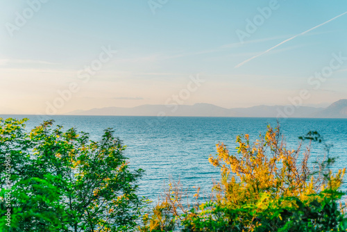 Sunset from the coast with a view of the The Rio-Antirrio bridge and mountains with the sea near the city of Patra in Greece photo