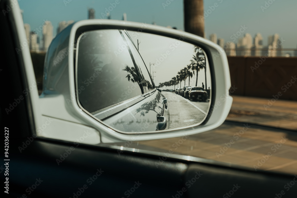 Reflection of a scenic road with palm trees in car side mirror with coastal drive vibes Reflection of a scenic road with palm trees in car side mirror with coastal drive vibes