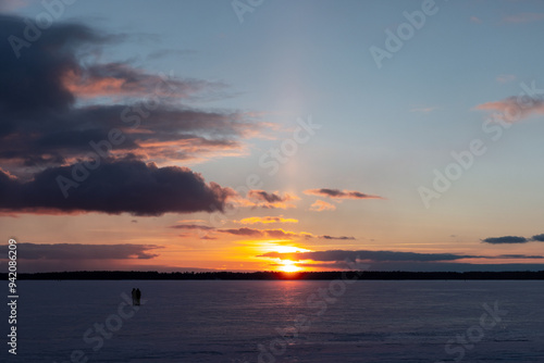 Winter landscape with frozen Baltic Sea coast at sunset