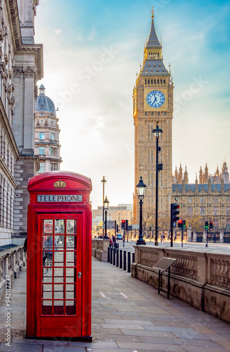 Canvas Print Red telephone box on Parliament square and Big Ben tower, London, UK