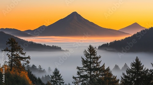  A photo of a mountain shrouded in mist, surrounded by trees in the foreground, and the sun sinking in the background