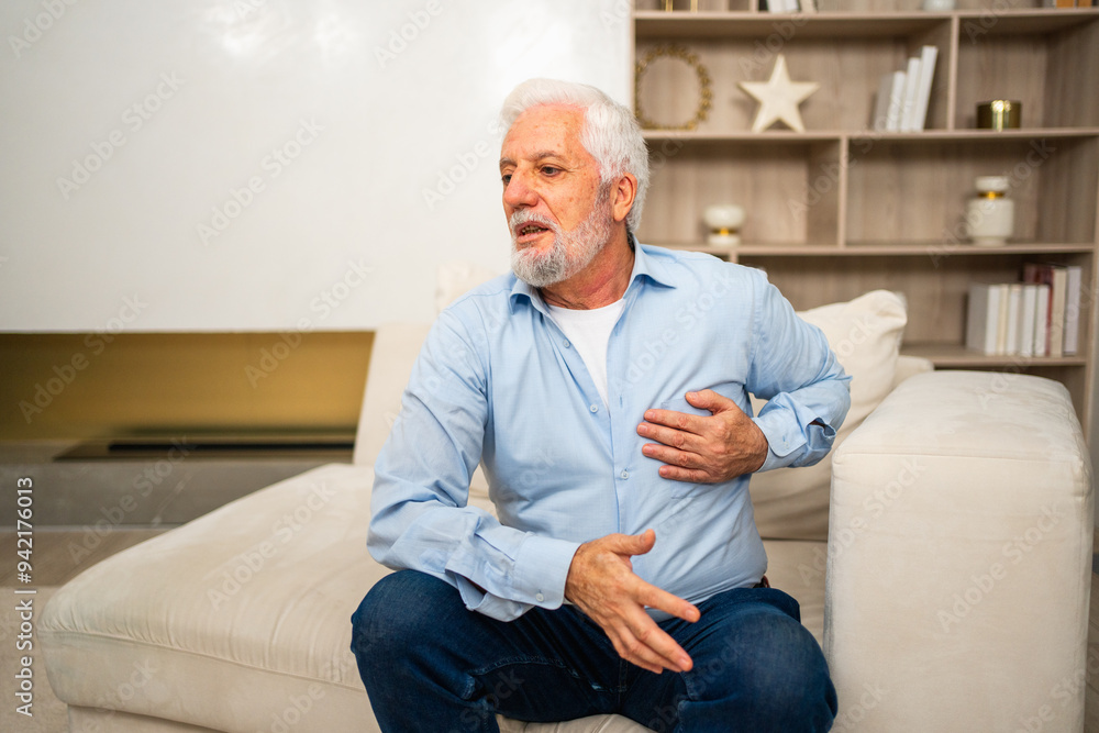 Pain on heart, heart attack. Unhappy middle aged senior man suffering from chest pain heart attack problems with health at home. Mature old senior grandfather touching chest experiencing infarction Pain on heart, heart attack. Unhappy middle aged senior man suffering from chest pain heart attack problems with health at home. Mature old senior grandfather touching chest experiencing infarction