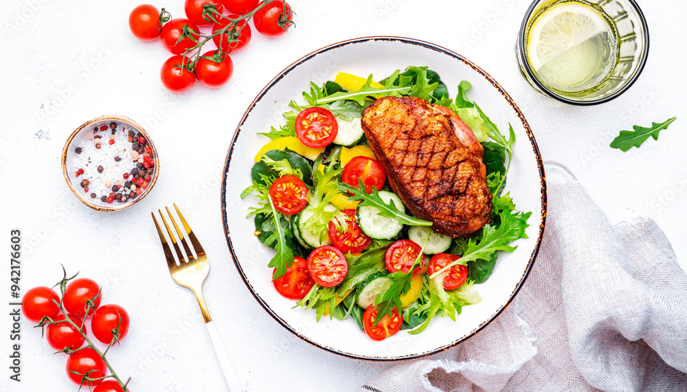 Tasty salad with grilled duck breast with vegetables and lettuce on white background, top view