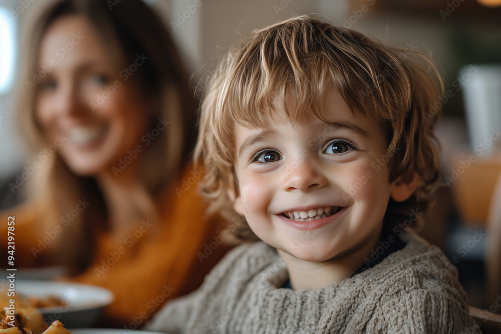 Joyful moment between a smiling boy and his mother during a delightful meal at home Joyful moment between a smiling boy and his mother during a delightful meal at home