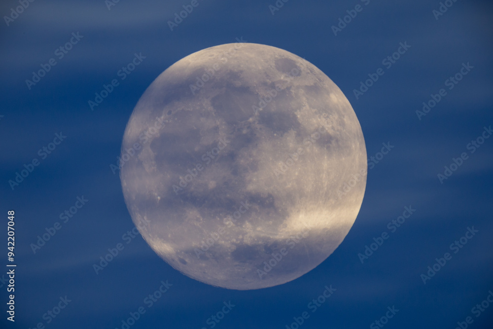 photograph of the full moon partially covered with clouds photograph of the full moon partially covered with clouds