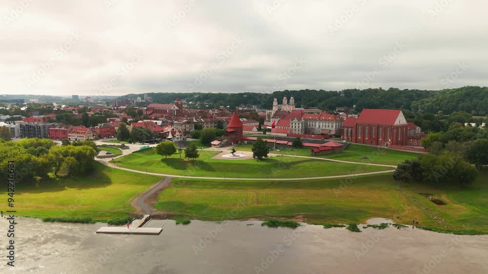 Drone shot of the historic old red brick Kaunas Castle in Kaunas old town, Lithuania. In the background there are churches, town hall and other old buildings. Drone shot of the historic old red brick Kaunas Castle in Kaunas old town, Lithuania. In the background there are churches, town hall and other old buildings.