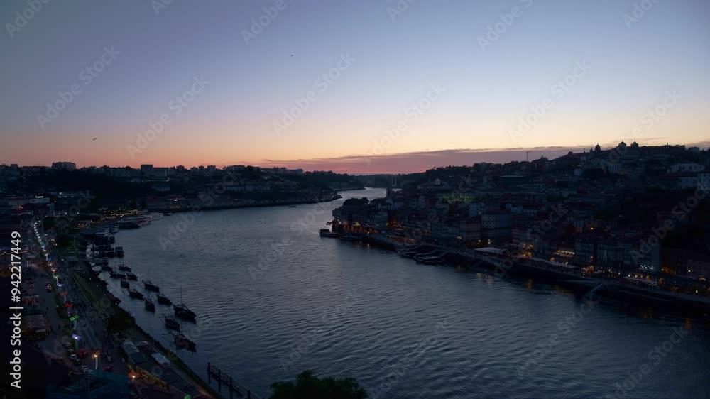 View of Porto and Douro river after sunset with orange and violet sky and clouds, wide view View of Porto and Douro river after sunset with orange and violet sky and clouds, wide view