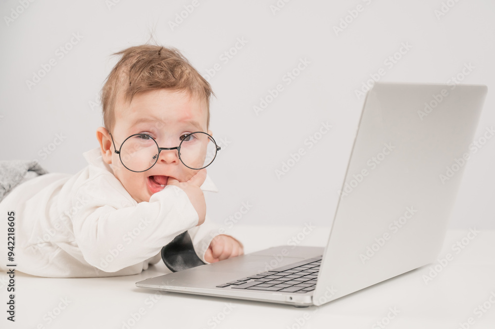 Cute baby in glasses and suit working on laptop. Cute baby in glasses and suit working on laptop.