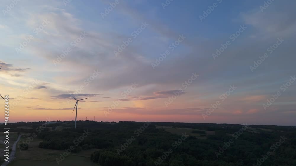 Scenic Aerial view of wind turbines farm in sunset time. Wind turbine producing alternative energy Scenic Aerial view of wind turbines farm in sunset time. Wind turbine producing alternative energy