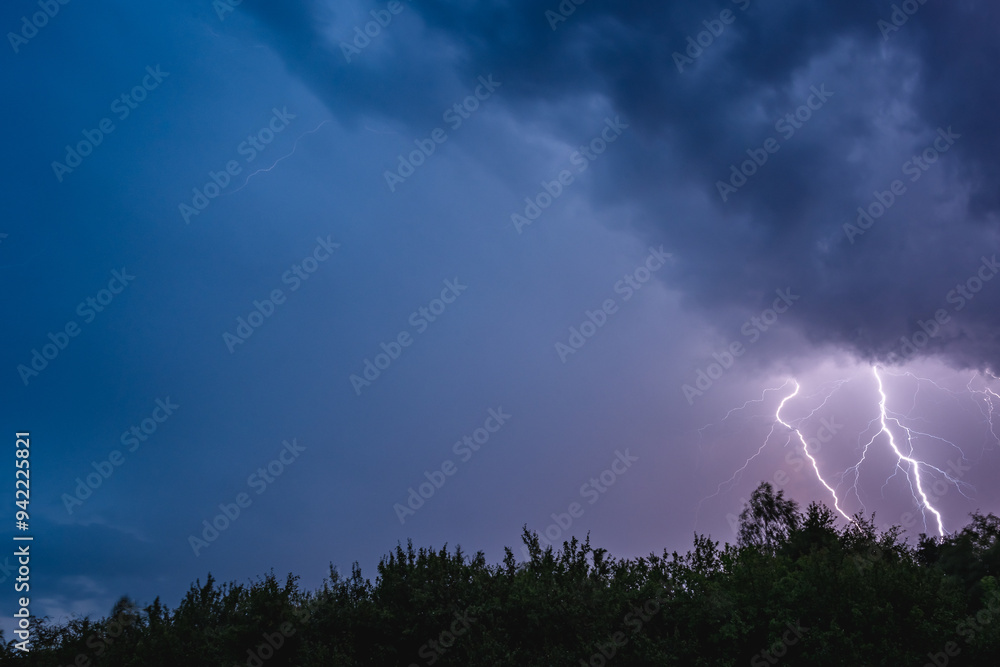 Thunderstorm, electrostatic discharge in the night sky, branching lightning high above the clouds. View of the dark sky. Thunderstorm, electrostatic discharge in the night sky, branching lightning high above the clouds. View of the dark sky.