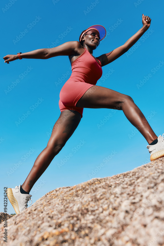 Active woman in sporty outfit climbing a rock against a clear blue sky, showcasing determination and strength Active woman in sporty outfit climbing a rock against a clear blue sky, showcasing determination and strength