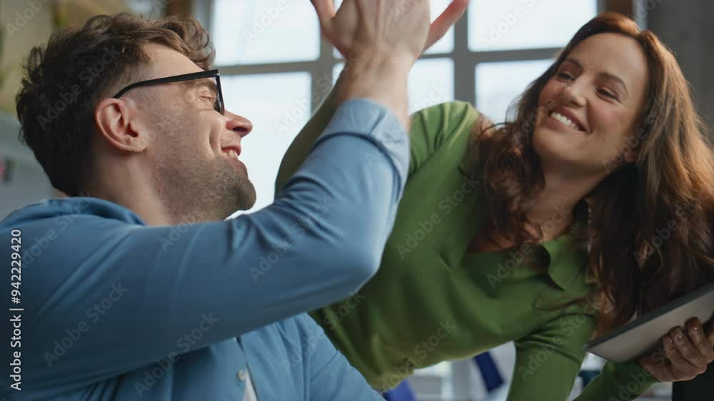 Two coworkers laughing video calling by computer in creative agency closeup Two coworkers laughing video calling by computer in creative agency closeup
