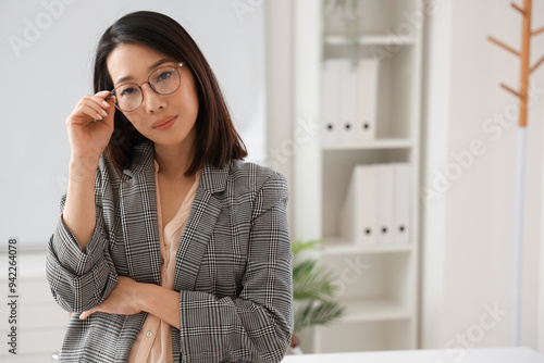 Free Download Beautiful Asian businesswoman in stylish eyeglasses in office - GFXLoad