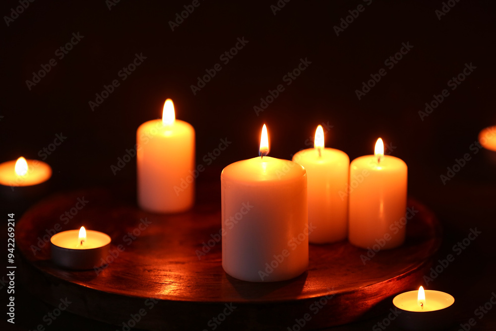 Beautiful burning candles on black background Beautiful burning candles on black background