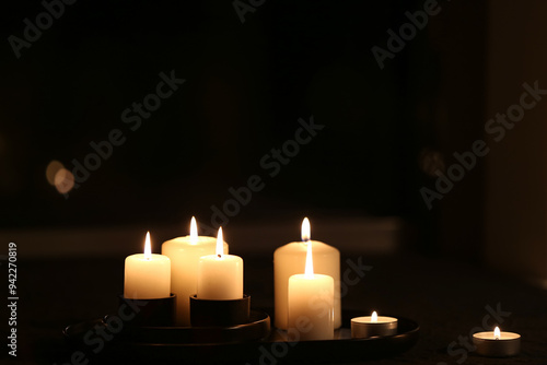 Burning candles on dark bac...