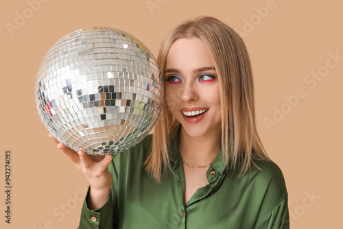 Smiling young woman holding...