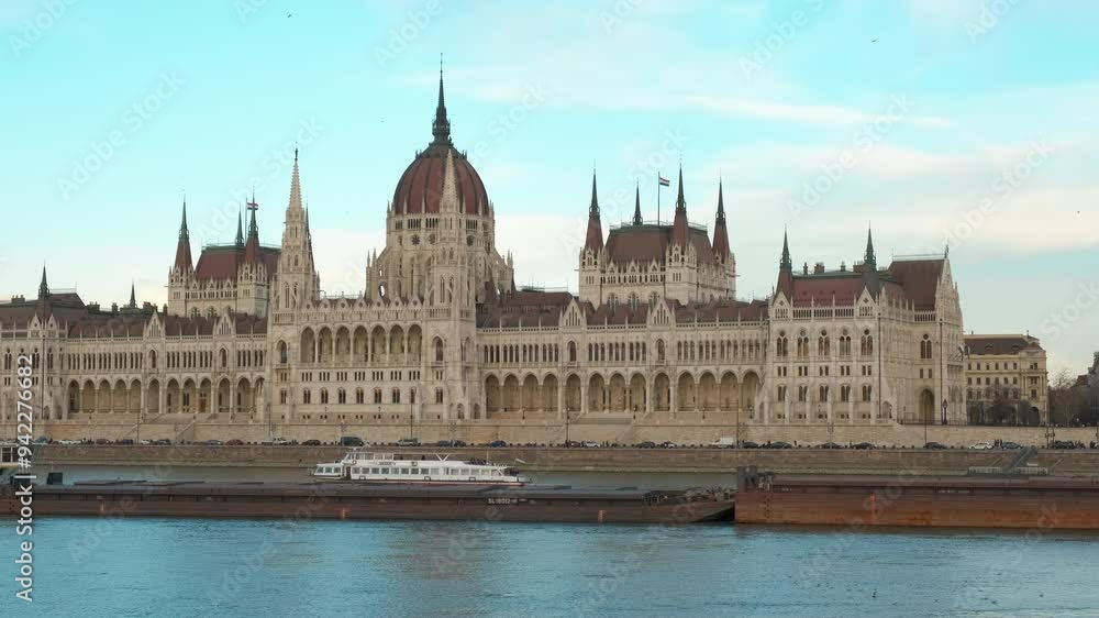 Tourist boat sails on the danube by parliament. A view of boats sailing on Danube river to admire the Budapest parliament building. Tourist boat sails on the danube by parliament. A view of boats sailing on Danube river to admire the Budapest parliament building.