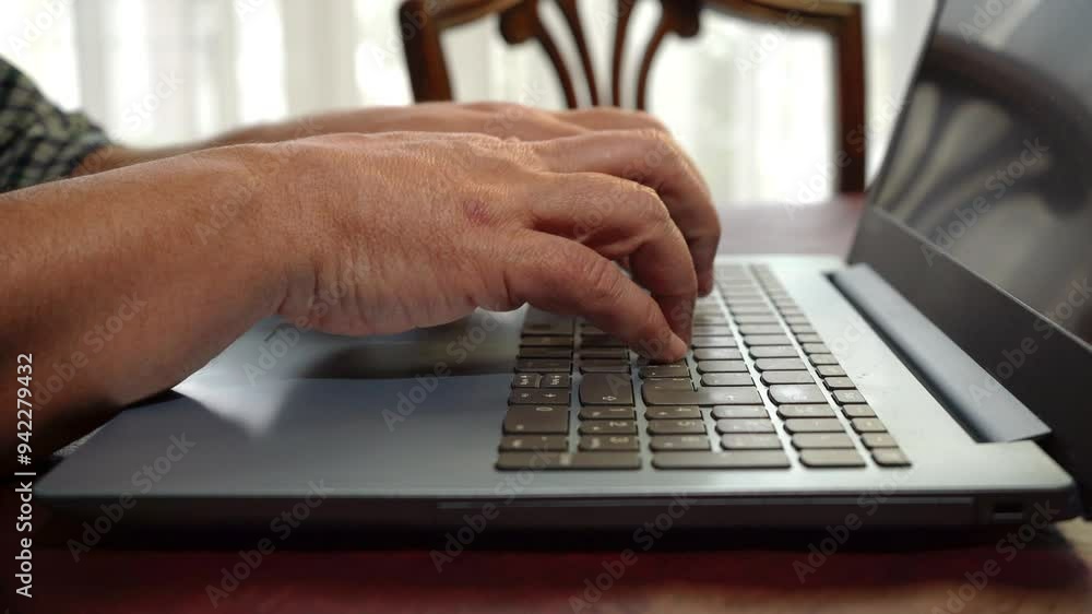 White Man working with his laptop or notebook at the table in his house. White Man working with his laptop or notebook at the table in his house.