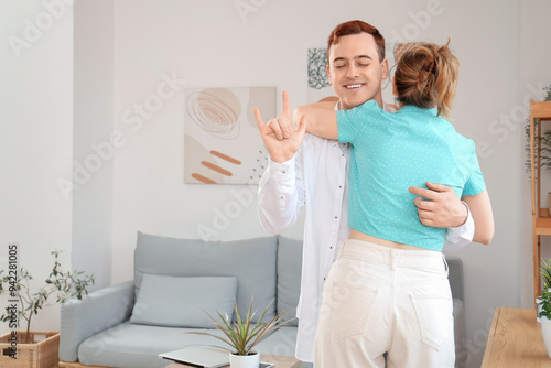 Young deaf mute man hugging...
