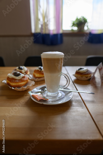 Cafe latte on table with donuts.