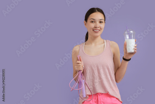 Smiling young woman holding...