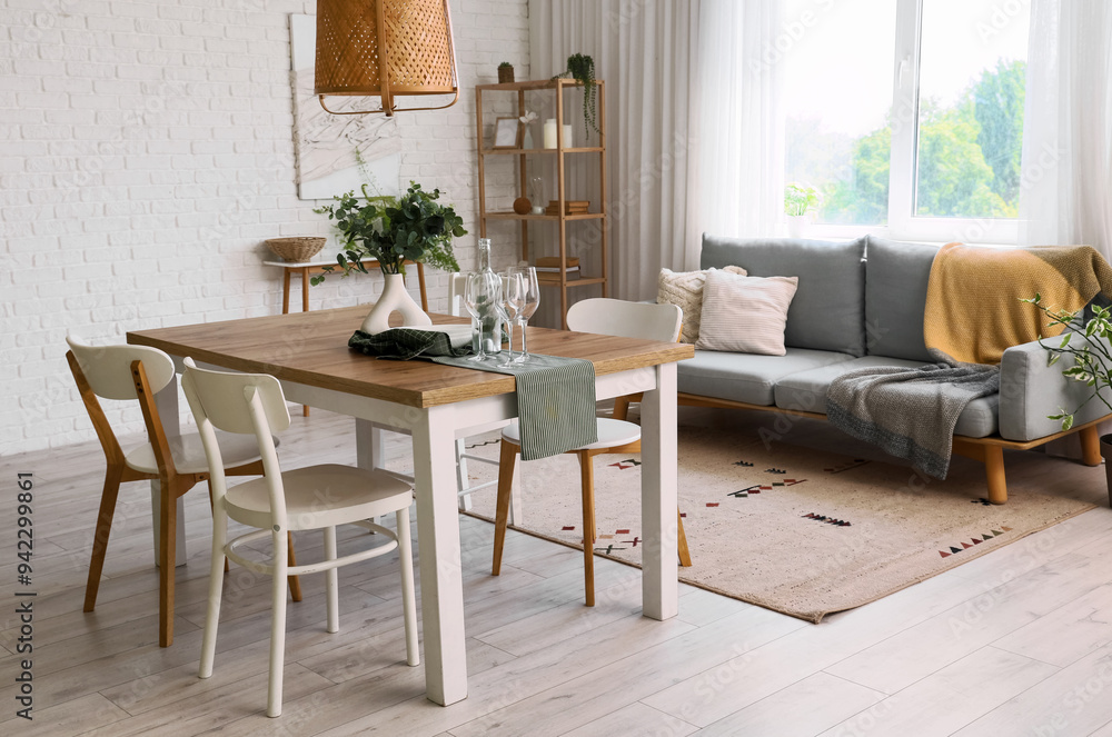Fototapeta premium Interior of light room with dining table and sofa